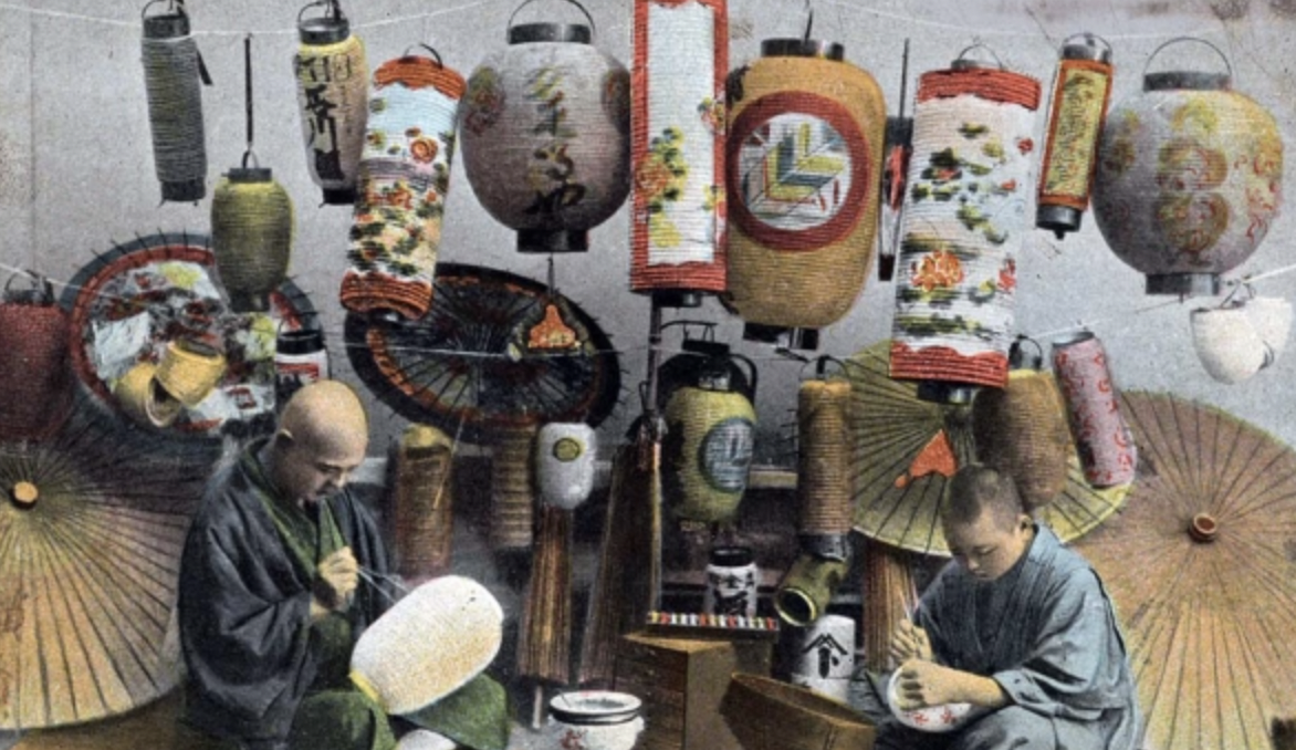 Two men paint lanterns, date unknown. 